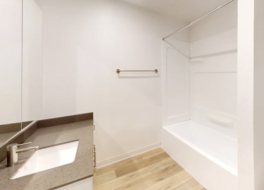 A white bathroom with a sink, toilet and bathtub.