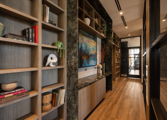 a hallway with wooden shelves and a marble countertop