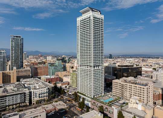 A cityscape with a tall building in the foreground.