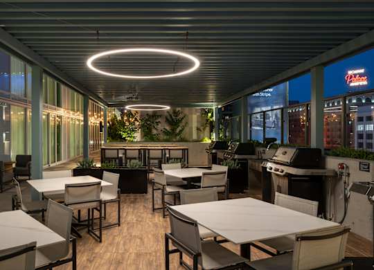 A restaurant with tables and chairs and a bar area.