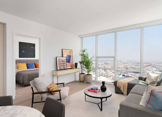 A living room with a large window overlooking the city.