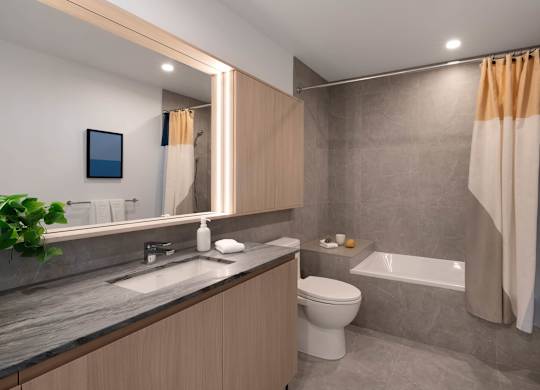 A modern bathroom with a toilet, sink, and bathtub.