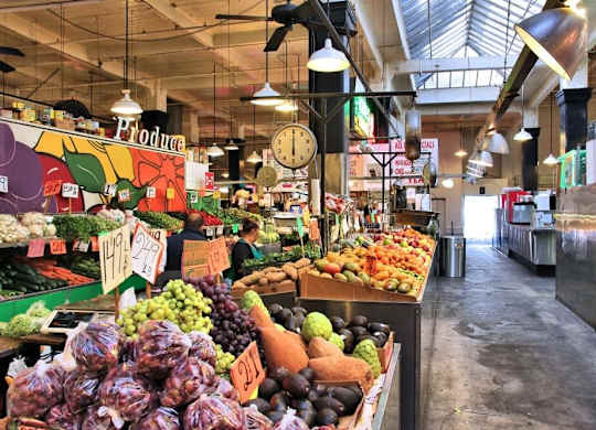 A market with a variety of fruits and vegetables on display.