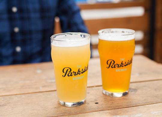 Two glasses of beer with the label