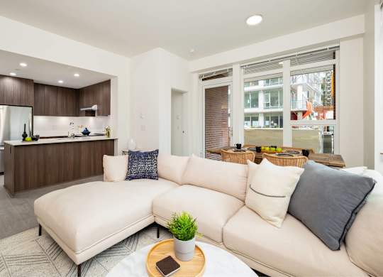 A modern living room with a white sofa and a wooden coffee table.