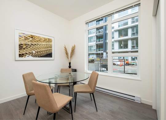 A dining room with a glass table and chairs.