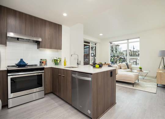 A modern kitchen with a stainless steel dishwasher and oven.