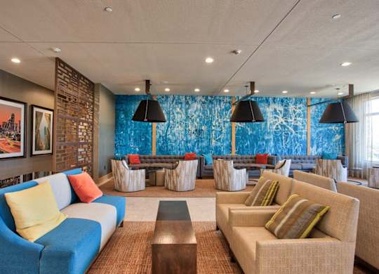 A living room with a blue couch and a brown coffee table.
