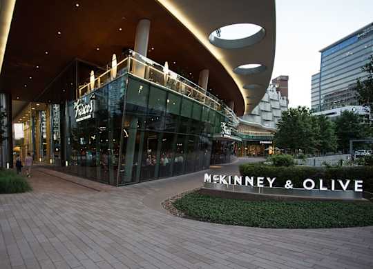 McKinney & Olive storefront with people walking by.