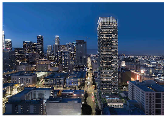 A cityscape at night with a tall building in the foreground.