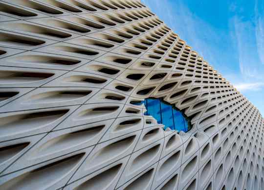 A building with a unique design and a blue sky in the background.