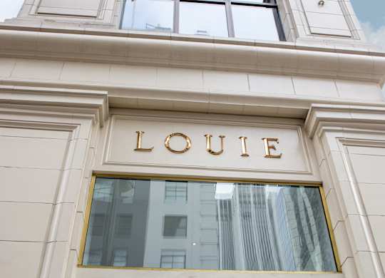 A building with a window and the word LOUIE on it.