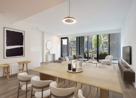 a living room and dining room with a wooden table and chairs