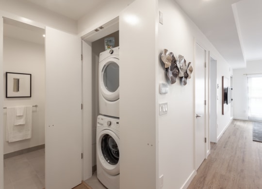 a washer and dryer in a white laundry room