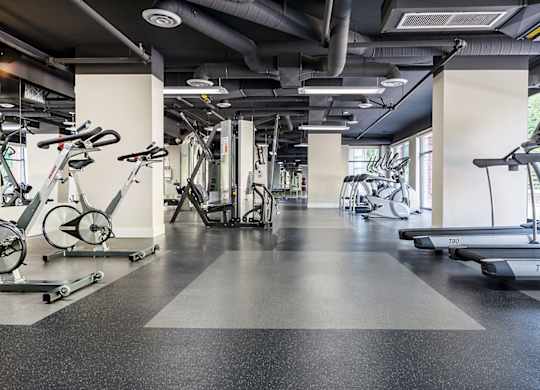 A gym with treadmills and exercise bikes.