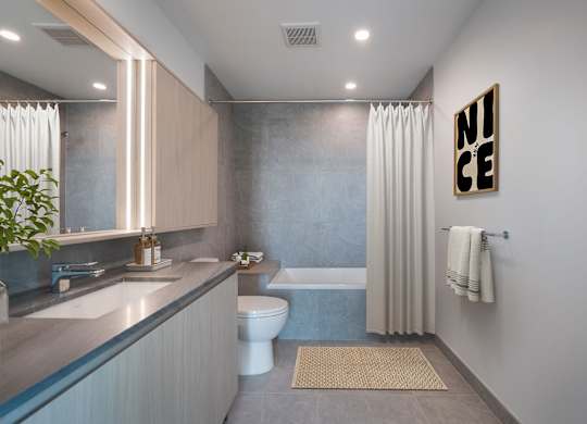 A bathroom with a toilet, sink, and a mirror.