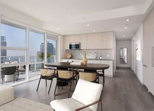 A modern kitchen with a dining table and chairs.