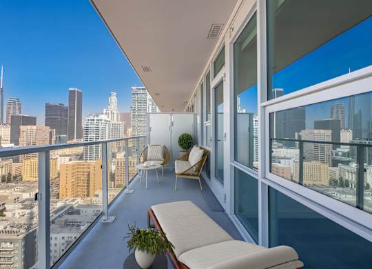 A balcony with a view of the city skyline.
