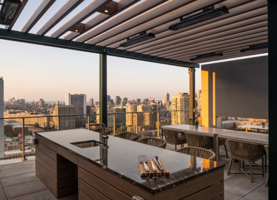 a terrace with a table and chairs and a view of a city