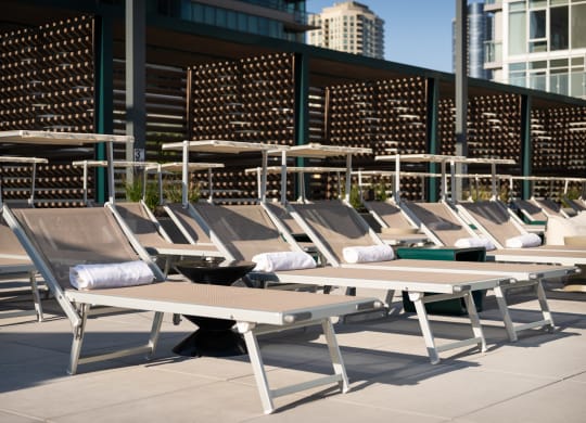 a row of chaise lounges on the roof of a building
