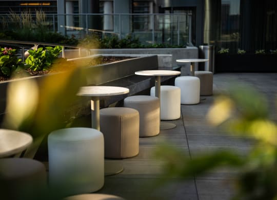 a row of tables and stools on a terrace
