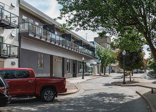 A red pickup truck is parked on the side of a street at B Flats Apartments, Bremerton, 98337