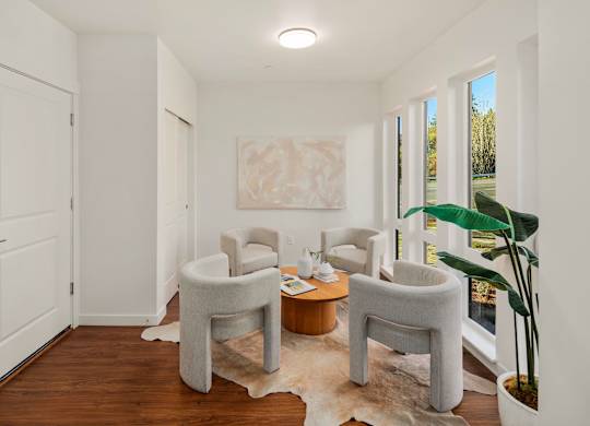 A white room with a table and chairs. at The Narrows at Clare Apartments , Apartments, Bremerton, WA