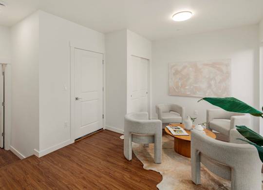 A living room with white walls and wooden floors. at The Narrows at Clare Apartments , Bremerton, 98310