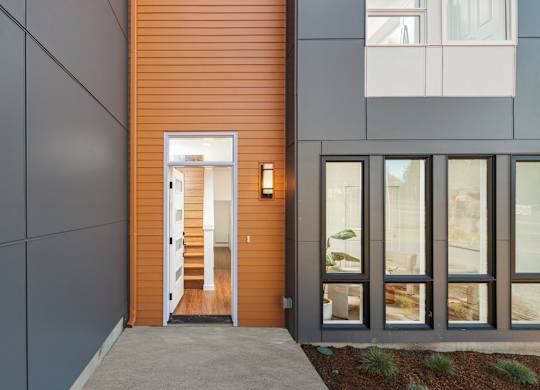 A modern house with a wooden door and glass windows. at The Narrows at Clare Apartments , Washington