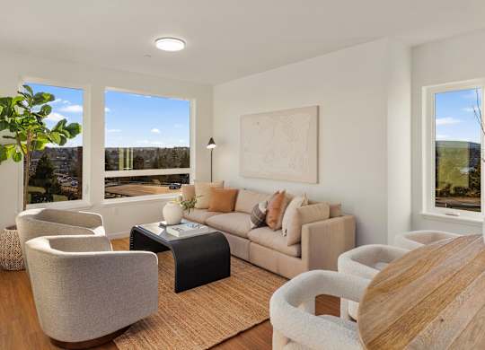 A living room with a couch, chairs, and a coffee table. at The Narrows at Clare Apartments , Washington, 98310