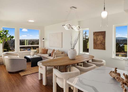 A modern living room with a wooden table and white chairs. at The Narrows at Clare Apartments , Apartments, Bremerton, WA