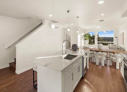 A modern kitchen with white cabinets and a large island. at The Narrows at Clare Apartments , Bremerton, WA, 98310