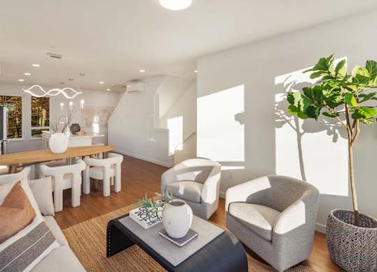 A living room with a grey sofa, a coffee table, and a potted plant. at The Narrows at Clare Apartments , Bremerton, Washington