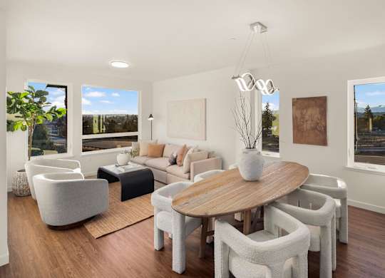 A modern living room with a large table and chairs. at The Narrows at Clare Apartments , Bremerton, 98310
