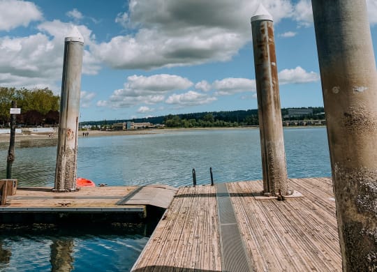 a wooden dock with three pillars on the side of it at Rivulet, Washington, 98383