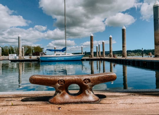 a dock with boats and clouds in the background at Rivulet, Silverdale, WA