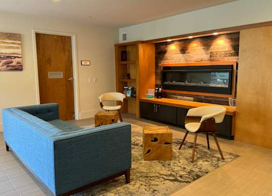 a living room with a couch and chairs and a television at Spyglass Hill Apartments, Bremerton