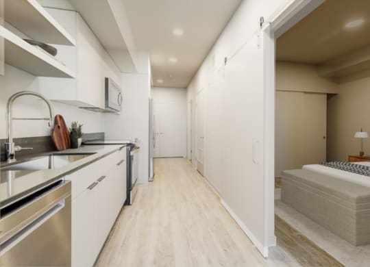 a bedroom with a bed and a sink in a room at Marina Square, Bremerton, WA, 98337