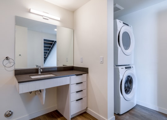 a bathroom with a sink and a washer and dryer at Marina Square, Washington
