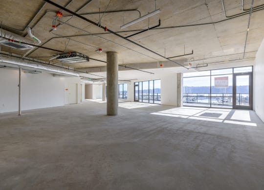 a large open space with concrete floors and a view of the water at Marina Square, Bremerton, 98337