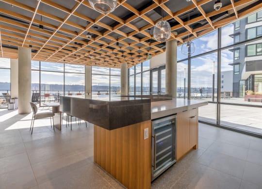 a kitchen with a large island in the middle of a room with floor to ceiling windows at Marina Square, Bremerton, Washington 98337