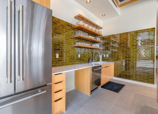 a kitchen with green tile and stainless steel appliances at Marina Square, Bremerton, WA