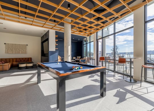 Game Lounge with a pool table, lounging couches, and floor to ceiling windows at Marina Square, WA 98337