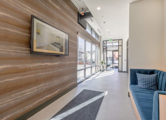 Hallway lobby with artistically textured walls and blue velvet loveseat at Marina Square, Bremerton