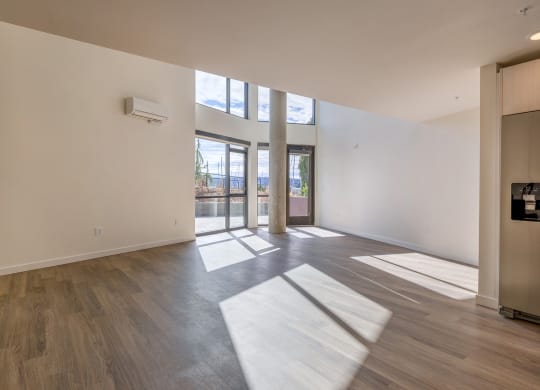a living room with hardwood floors and white walls at Marina Square, Bremerton, Washington 98337