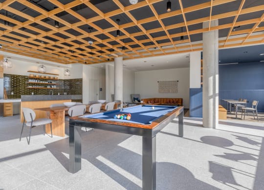 a games room with a pool table and a bar in the background at Marina Square, Bremerton