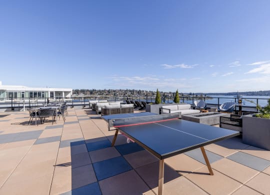 a terrace with a ping pong table and a view of the water at Marina Square, Bremerton, 98337