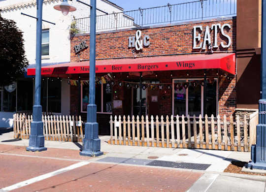 A restaurant named H & Eats is located on a street corner.