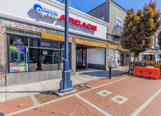 A brick sidewalk leads to a closed arcade.