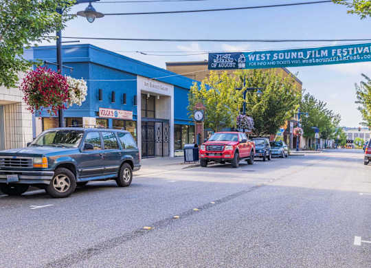 A blue car is parked on the side of the street.